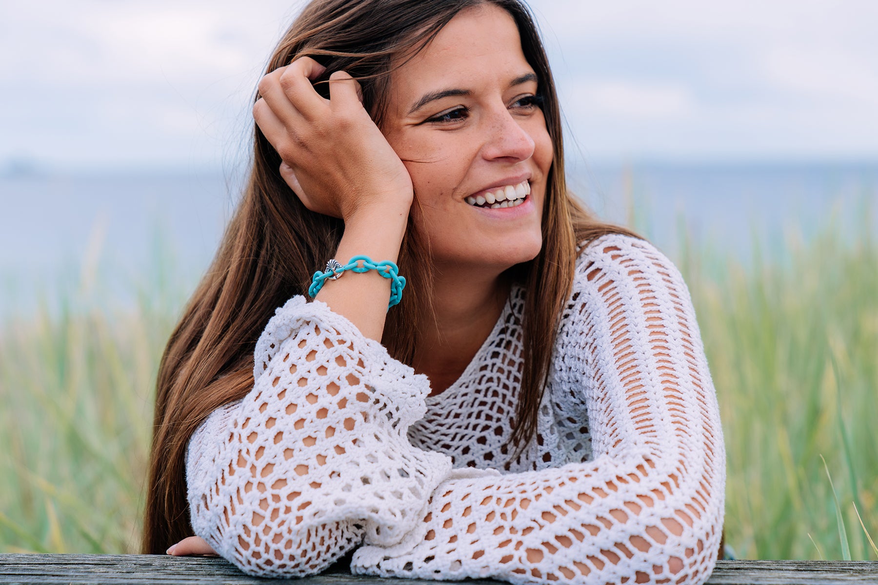 Model wearing bracelet from the ocean collection at the beach.