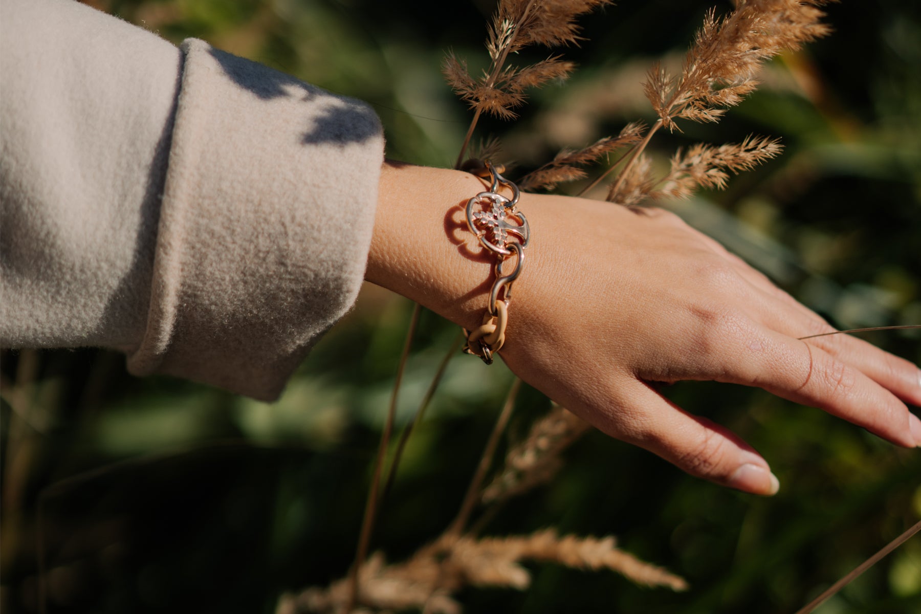 Model wearing X Jewellery bracelet in nature