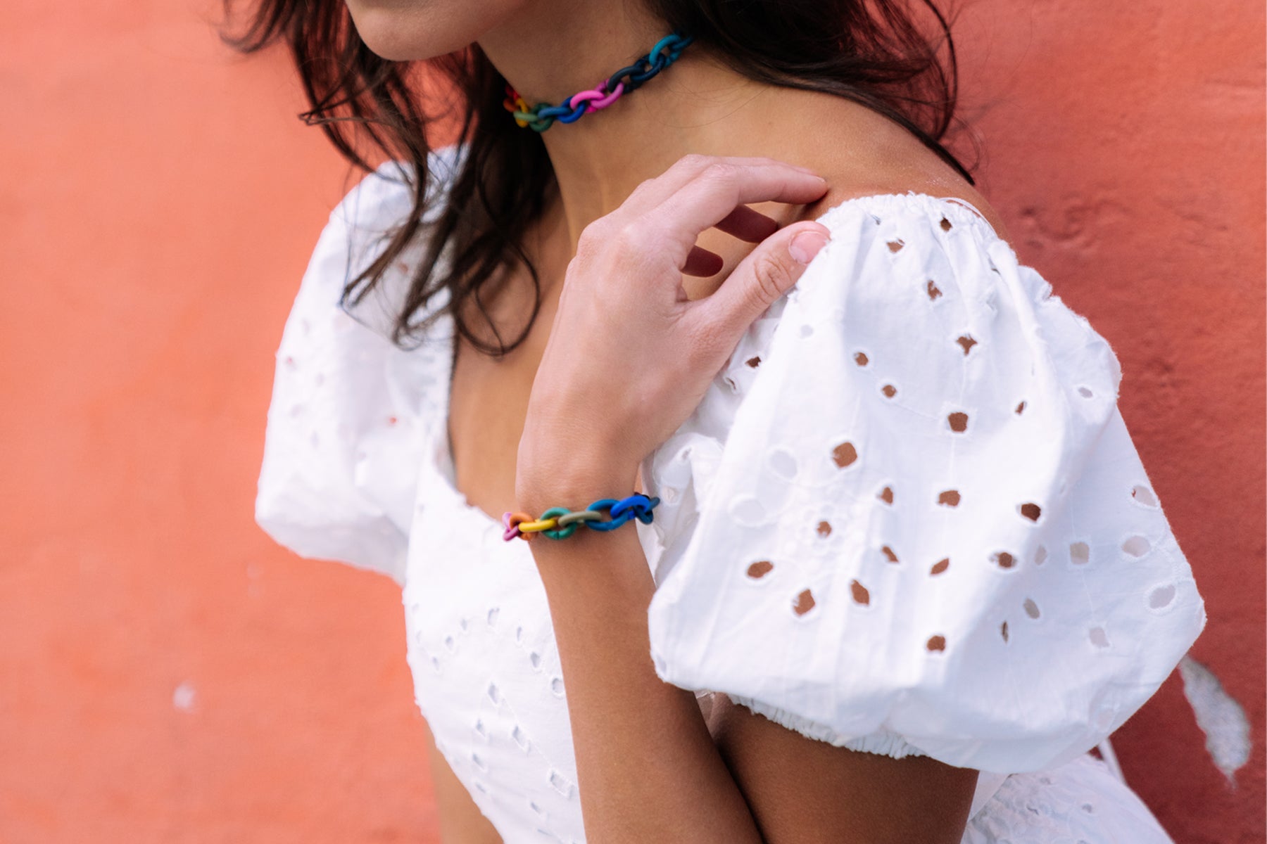Model wearing rainbow choker and bracelet from X Jewellery